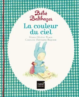 Couverture du livre Bébé Balthazar « La couleur du ciel » : un petit lapin bleu assis dans l'herbe qui lit un livre