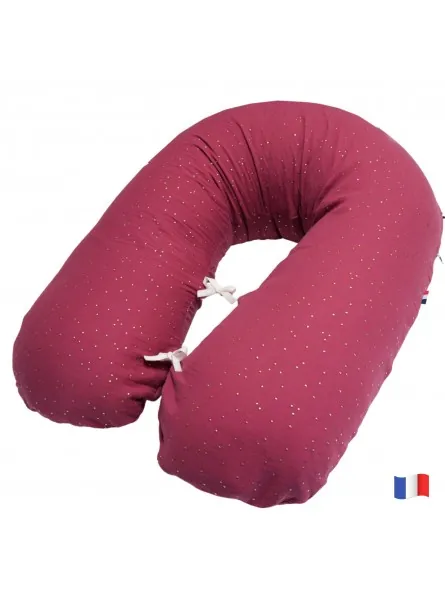 Un coussin d'allaitement en forme de U, prune à petits points dorés, fermé par des liens